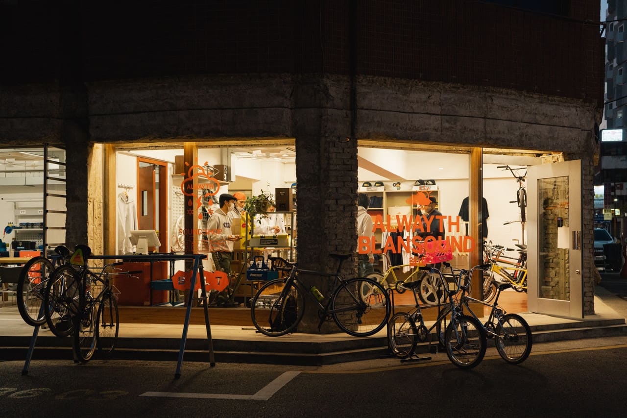 BOLT shopfront at night with illuminated windows and people visible inside
