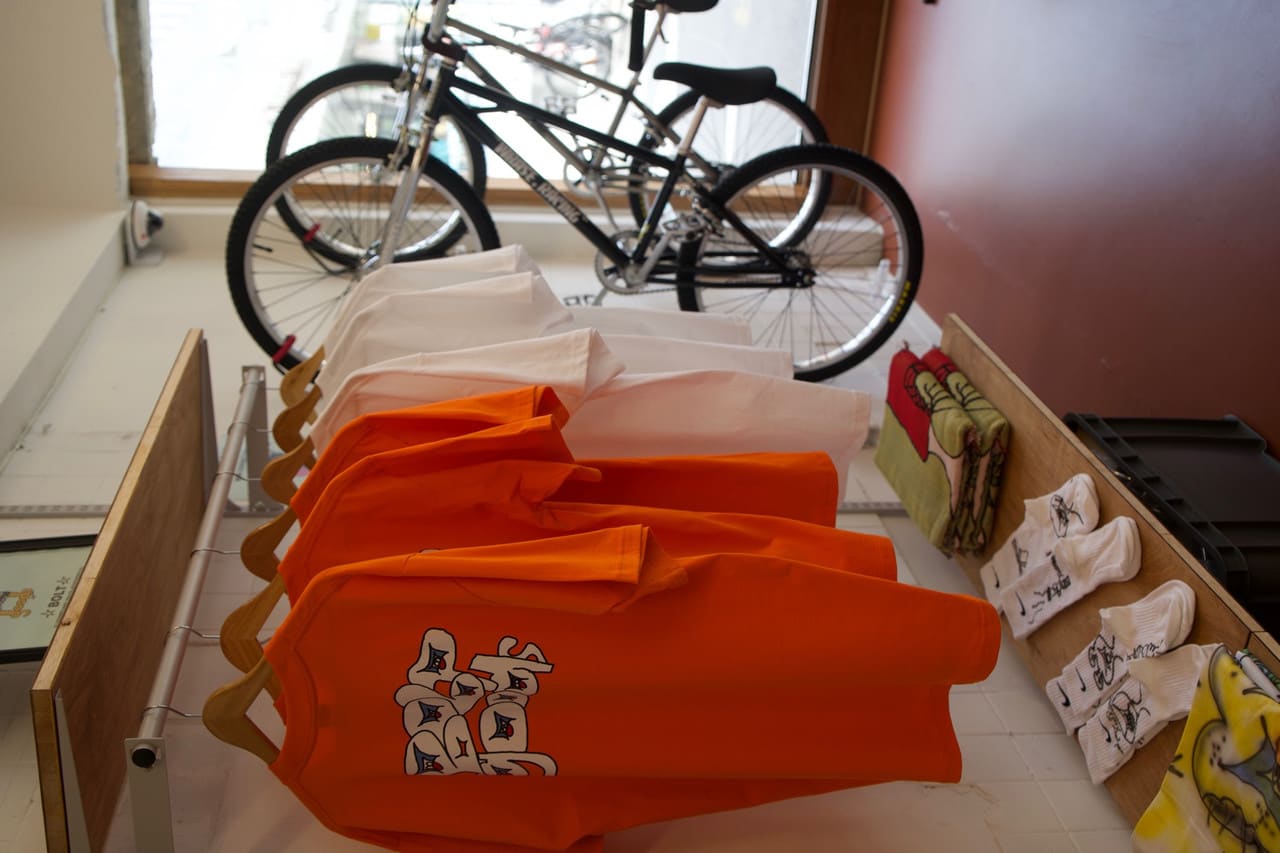 Clothing, socks and bicycles displayed by the windows inside BOLT